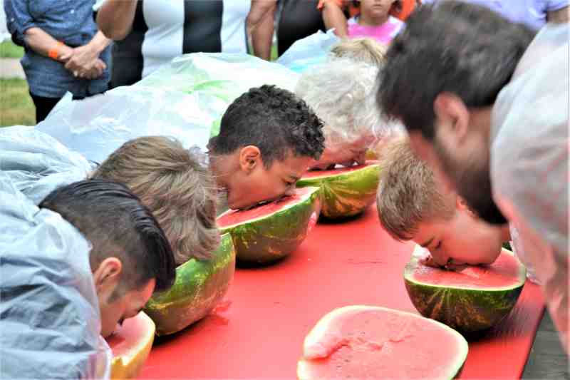 faces in water melons for a food eating contest