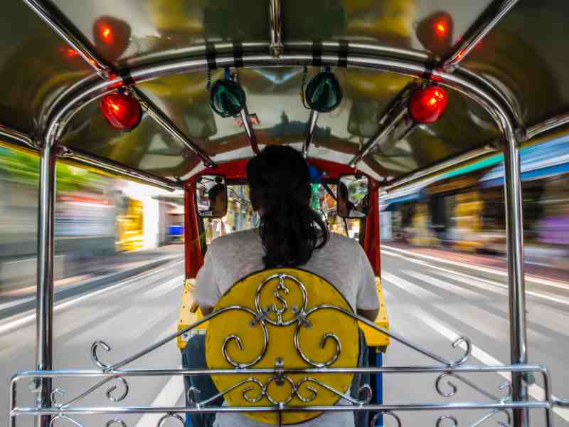 riding a tuk tuk in bangkok
