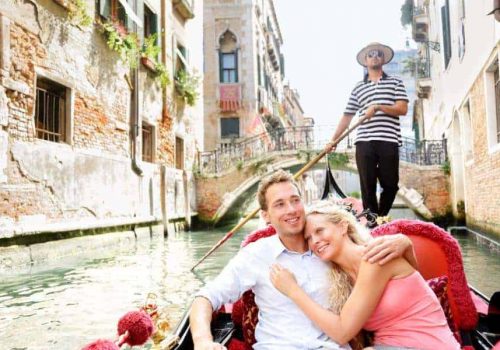 Romantic travel couple in Venice on Gondole ride romance in boat